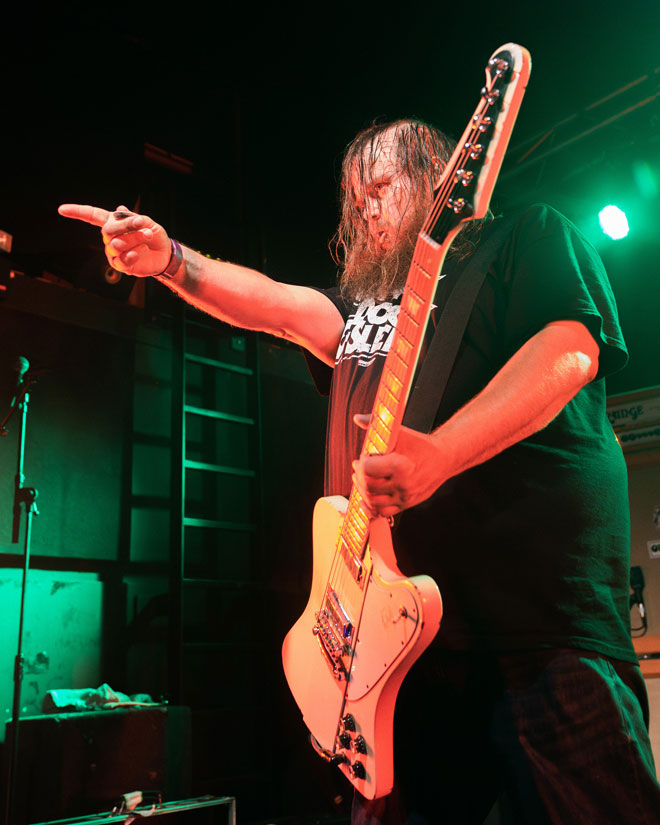 Low angle shot of Greenleaf guitarist performing in London