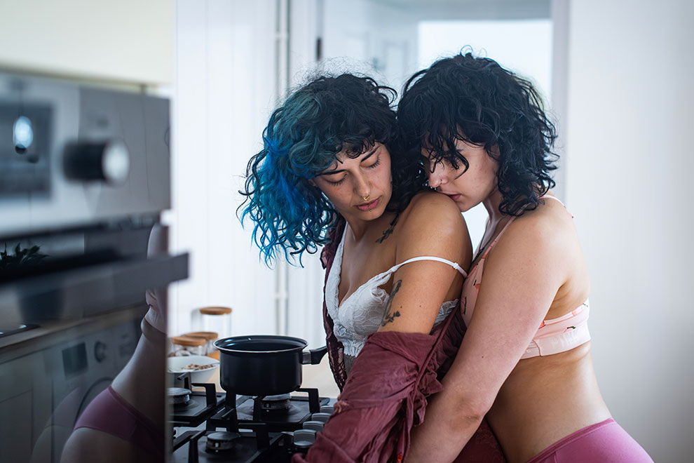 LGBTQ+ Couple embracing tenderly in a kitchen setting