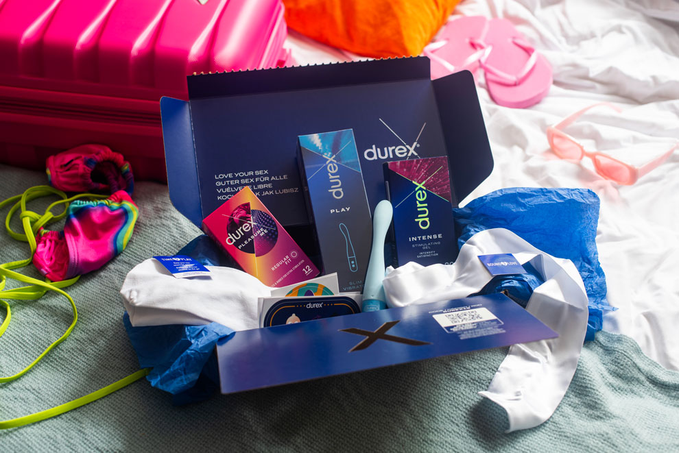 Open Durex gift box placed on a bed, holiday vibes