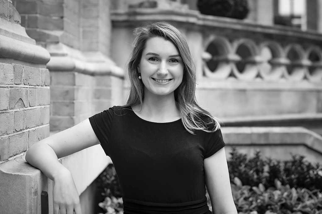 Female executive in black and white portrait, architectural background with natural light
