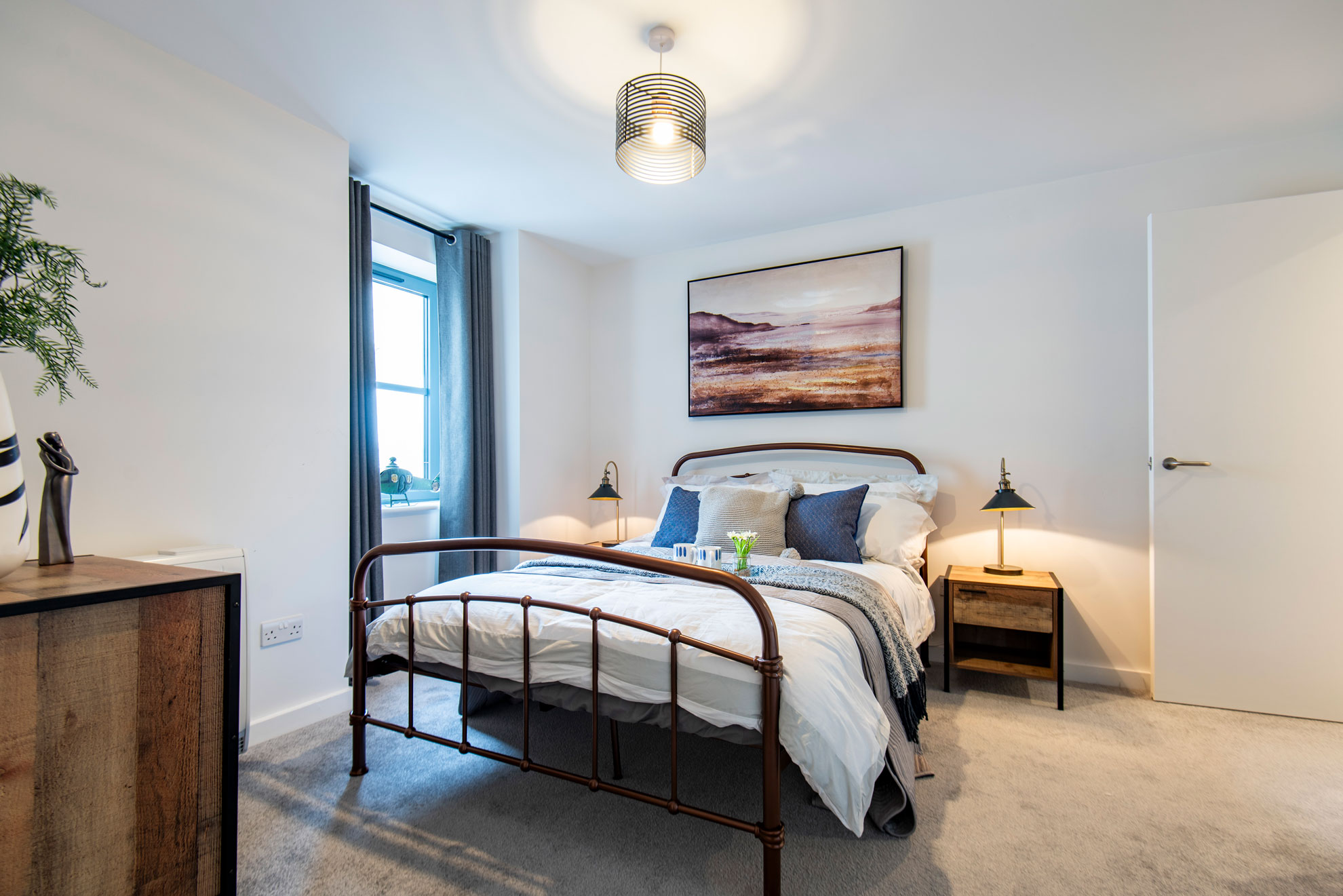 Bright bedroom with blue accents and soft lighting