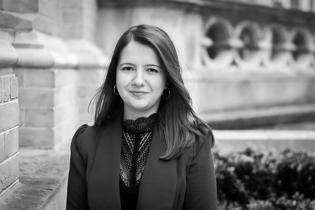 Female executive in black and white portrait, architectural setting with natural light
