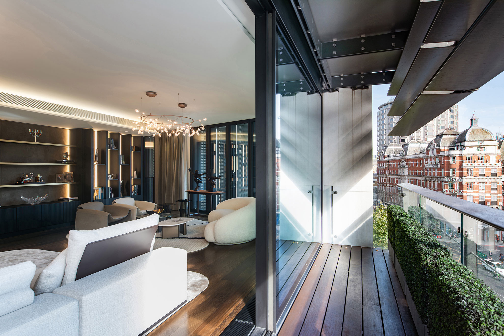 View from a balcony into a high-end, prestigious apartment, with designer sofas and details
