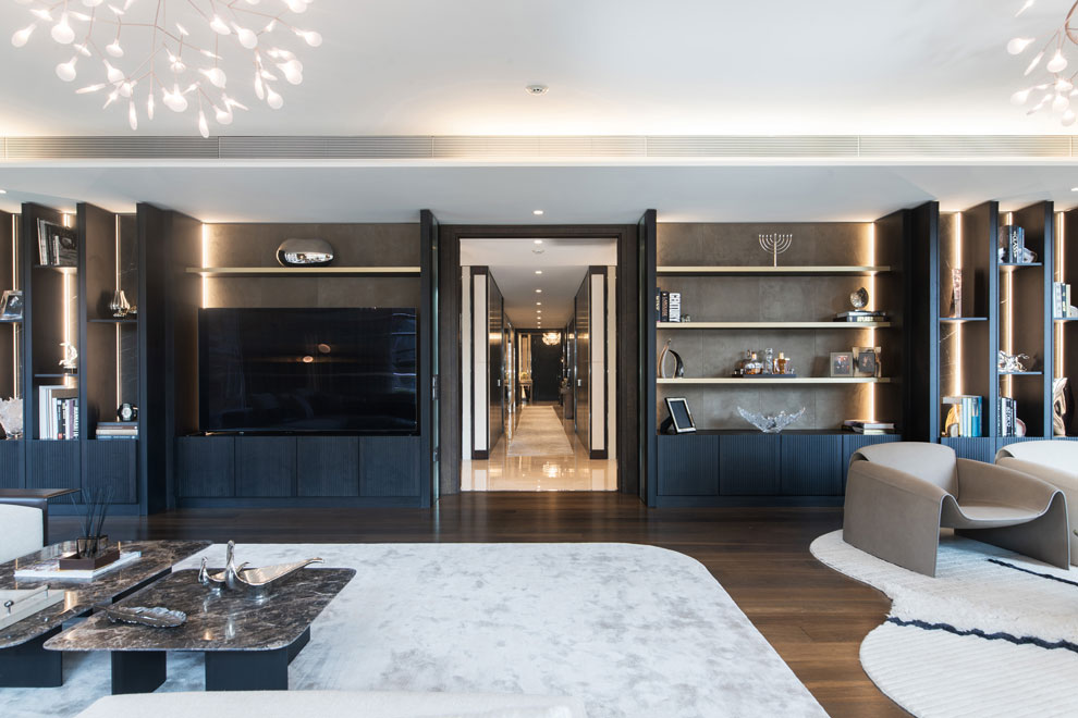 Living area in a high-end apartment, with a view down a very long hallway