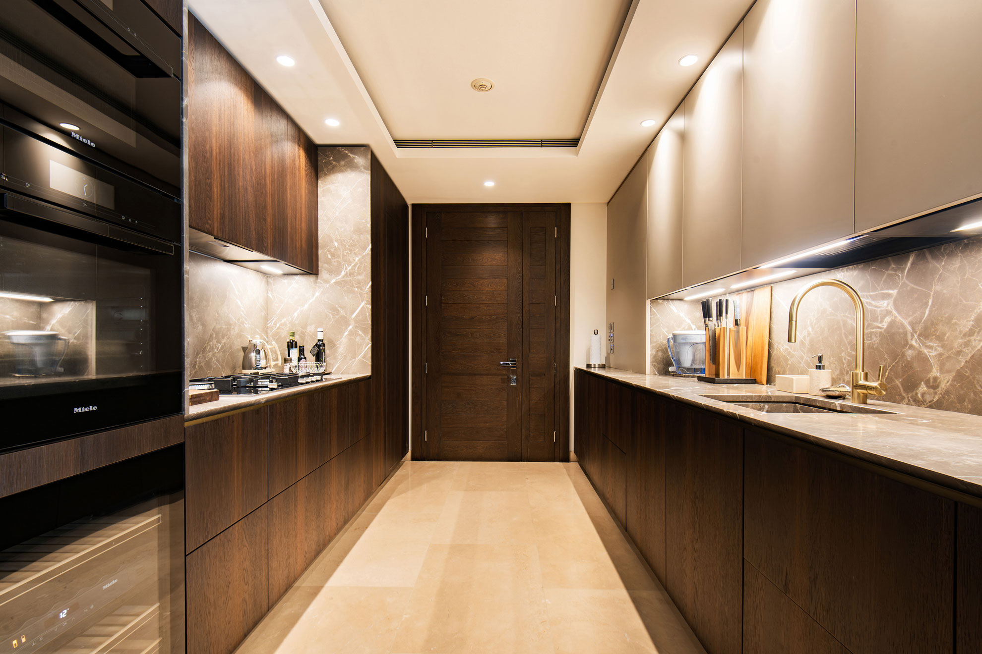 Stunning kitchen in a high-end, prestigious apartment, with dark brown and neutral fitted units