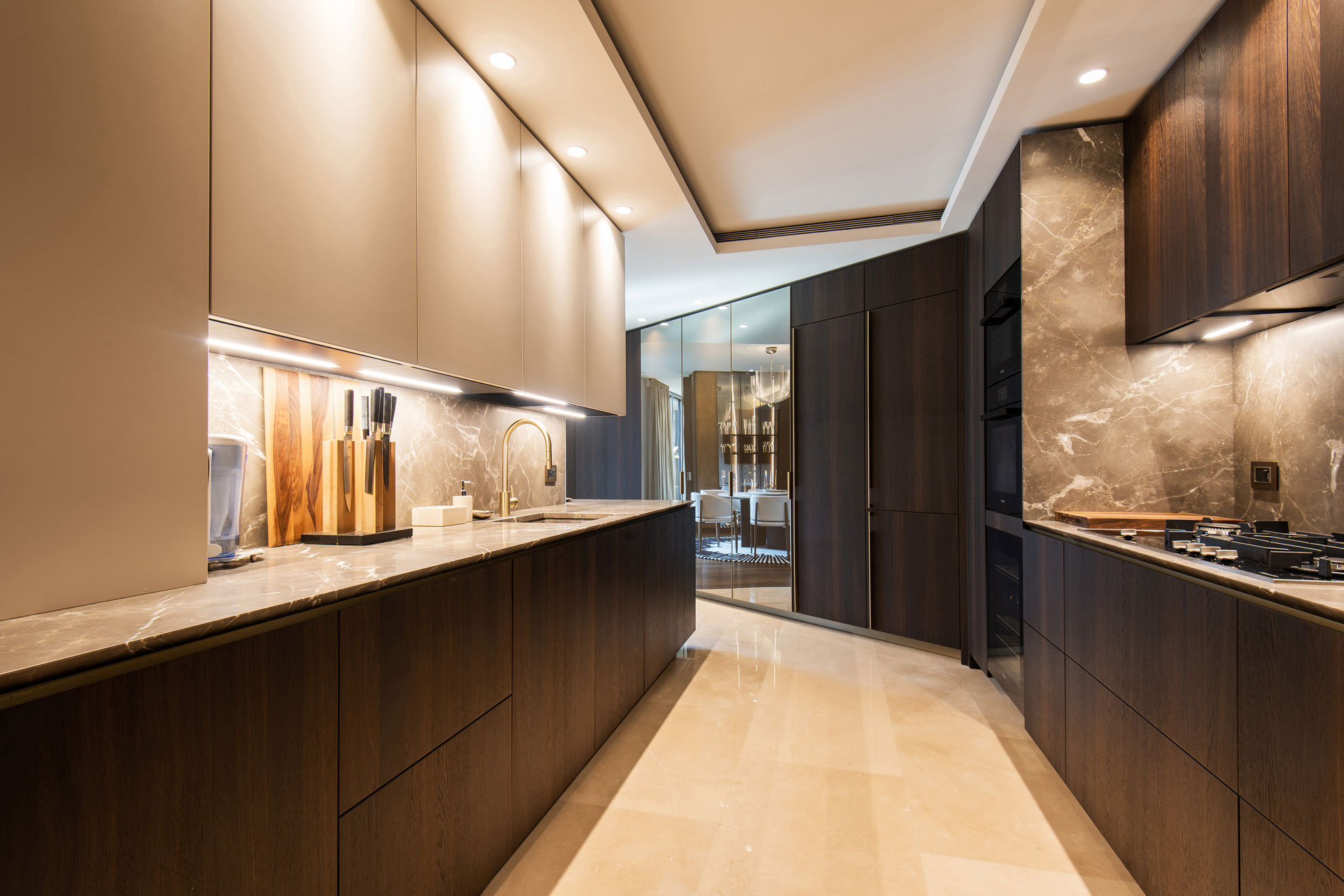 Stunning kitchen in a high-end, prestigious apartment, with dark brown and neutral fitted units