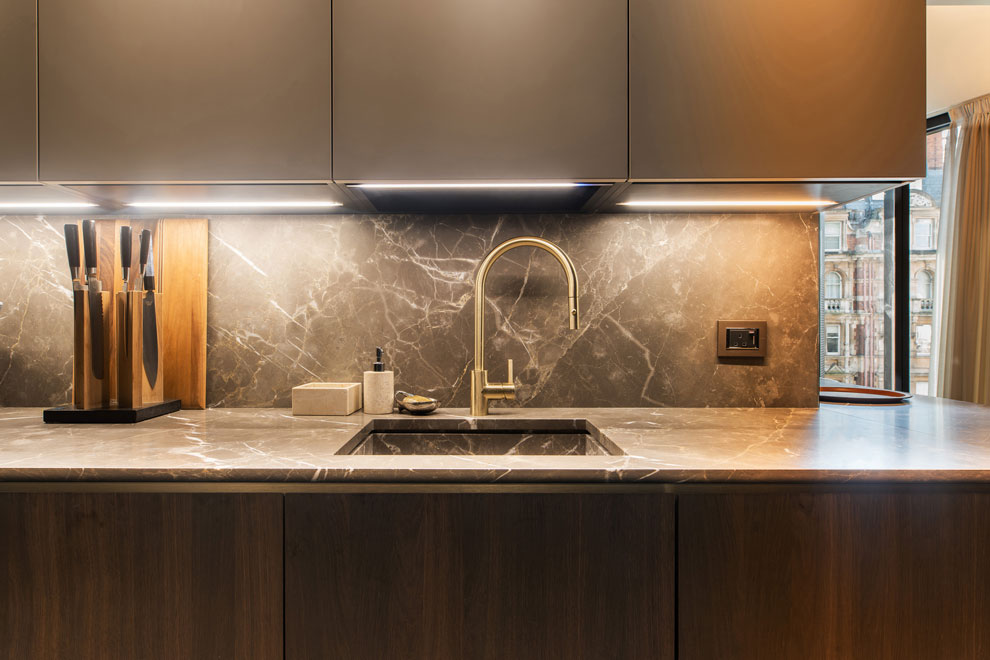 Stunning kitchen in a high-end, prestigious apartment, with dark brown and neutral fitted units