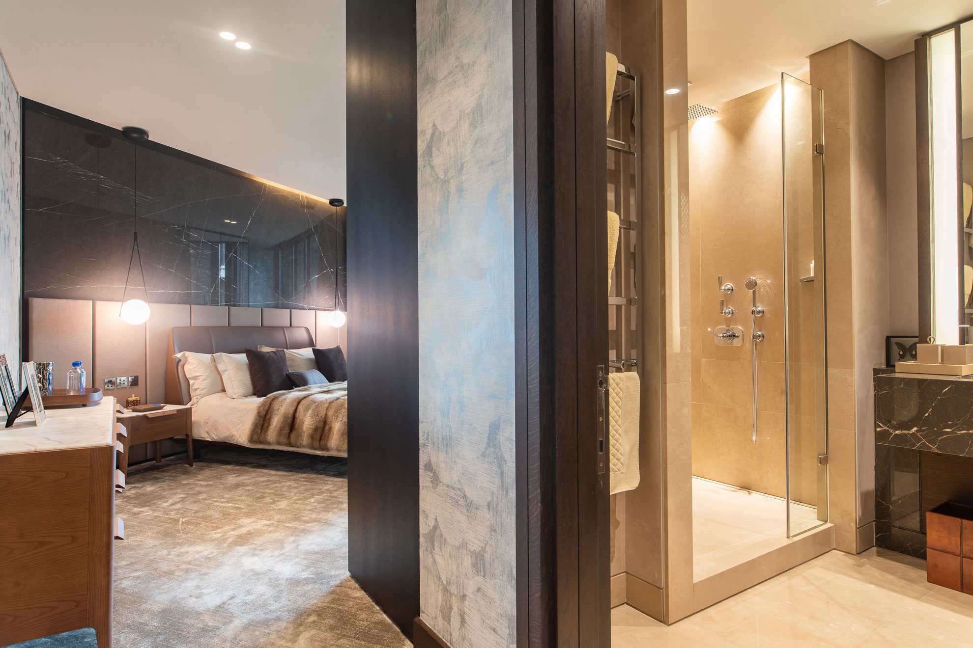 View into a large bedroom and adjoining en suite bathroom in a high-end, prestigious apartment