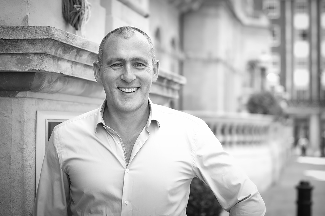 Professional man posing confidently in city environment, monochrome corporate image
