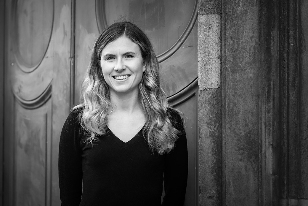Female executive in black and white portrait, architectural background with natural light
