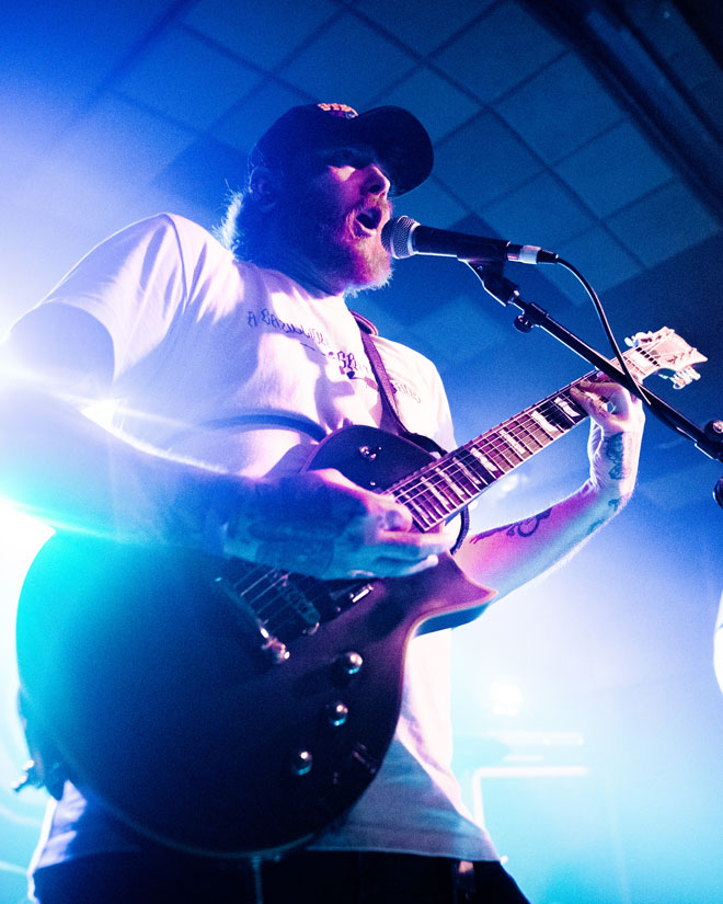 Low angle view of Urzah guitarist/vocalist performing in London