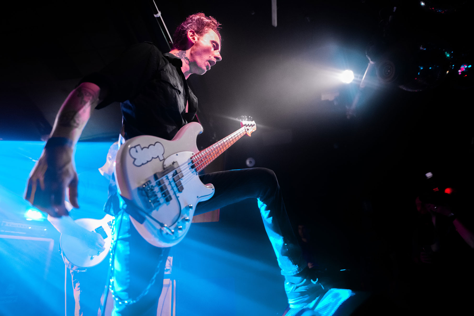 Low angle, dramatic view of Urzah bassist performing in London