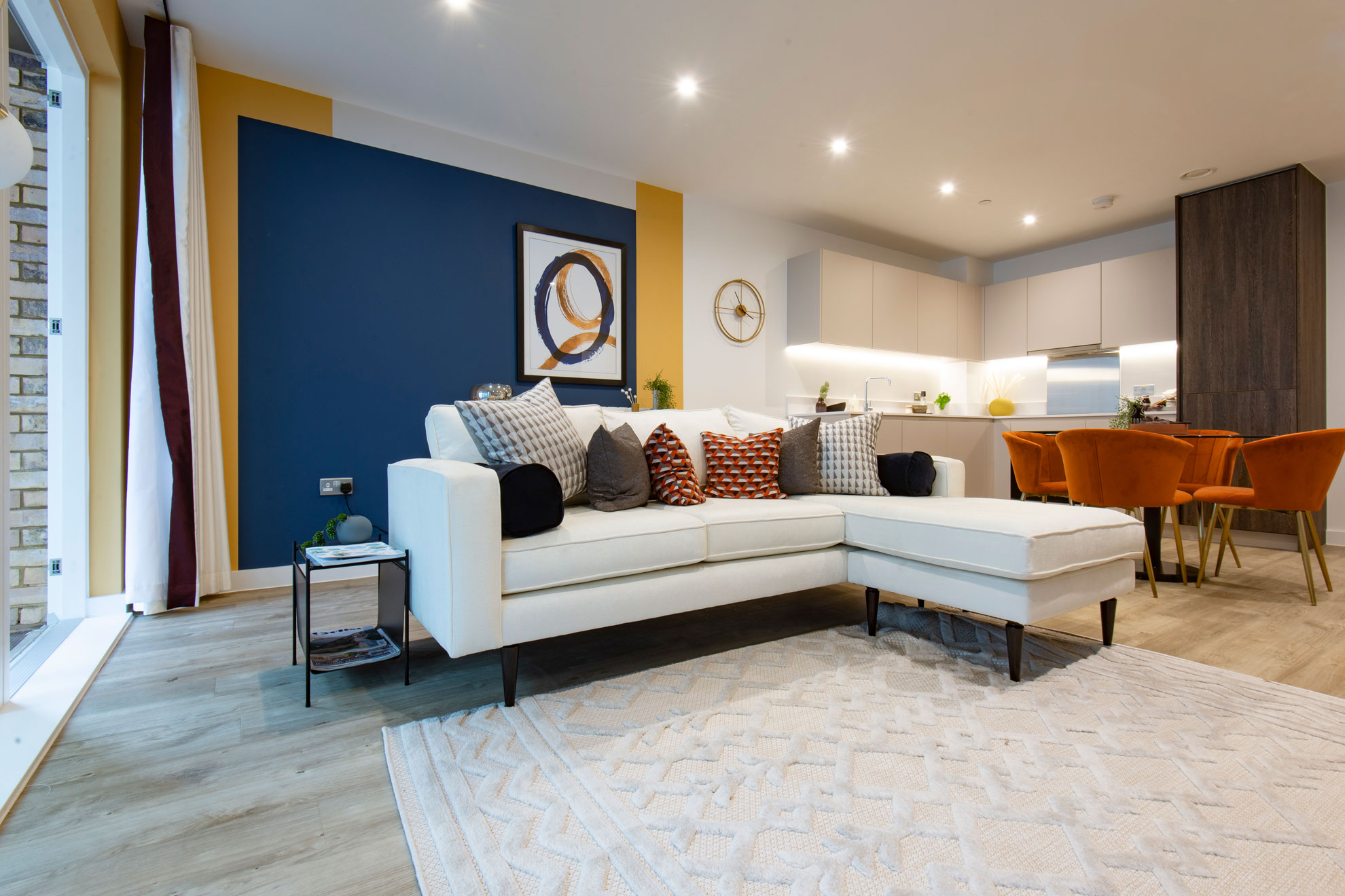 Modern, interior designed, open plan living room, dining area and kitchen with an open patio door