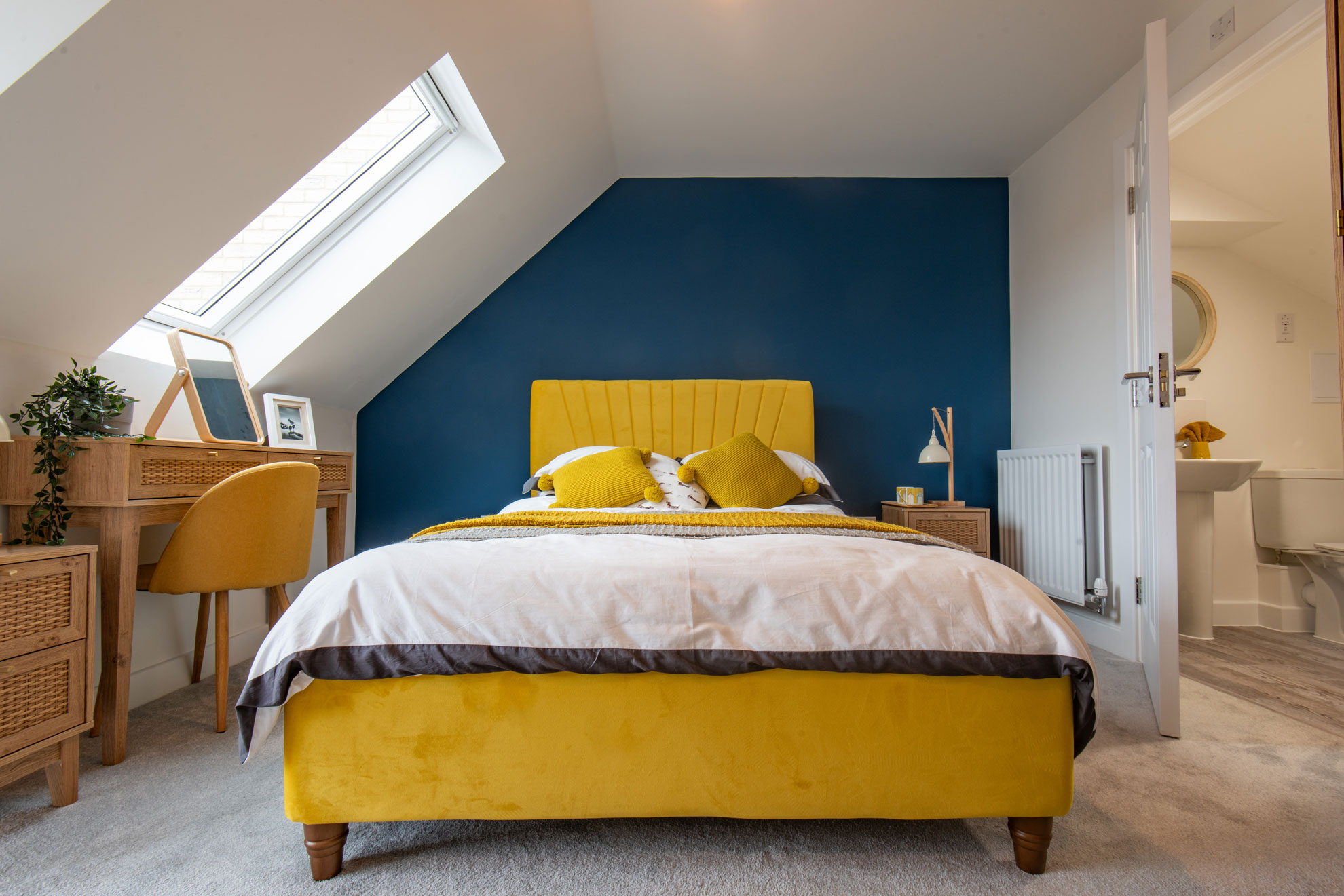 Interior designed modern bedroom with a bold dark blue and mustard colour palette