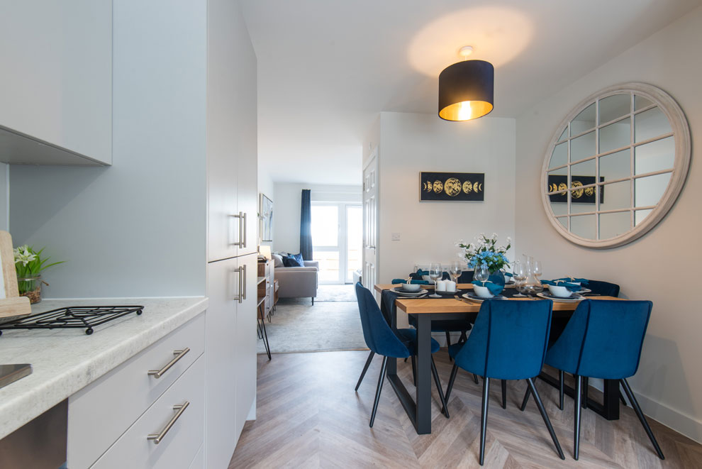 View of a kitchen and dining area with fitted appliances and units